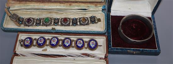 A gilt white metal and cabochon gem set bracelet, one other and a white metal bangle.